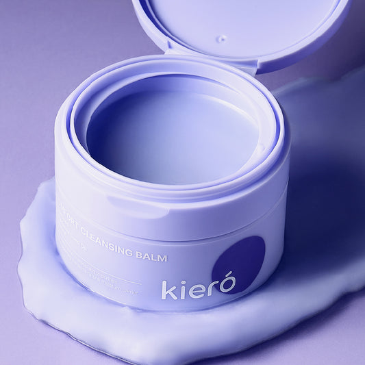 A high-angle, close-up shot of an open skincare product jar resting on a smear of its own textured contents.