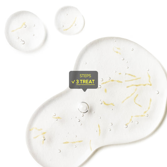 Macro photography of a clear serum or gel texture containing suspended yellow active ingredient particles